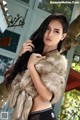 A woman in a fur coat posing for a picture.